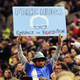 This photo taken March 25, 2016, shows Devonte Hart holding up a sign as then-Democratic presidential candidate Bernie Sanders spoke at a rally in Portland, Ore.